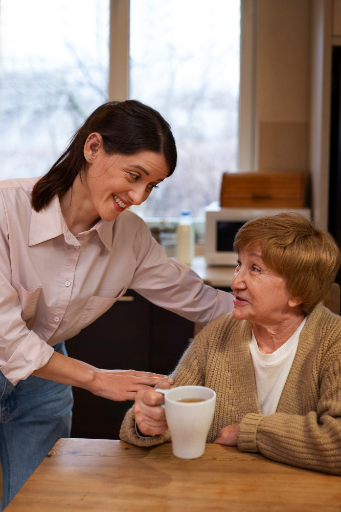 Caregiver comforting an elderly woman while providing compassionate personal care assistance in Fulton County, GA