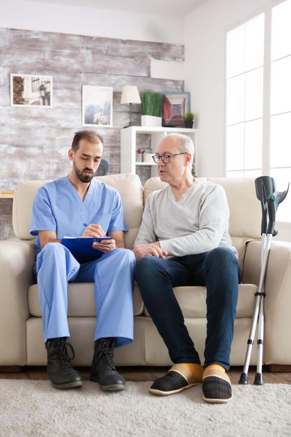 Caregiver discussing personalized memory care support with a senior man at home in Fulton County, GA