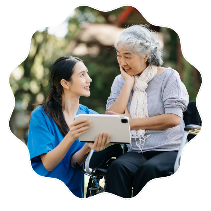 Caregiver speaking with a senior woman while discussing compassionate home care career support in Fulton County, GA